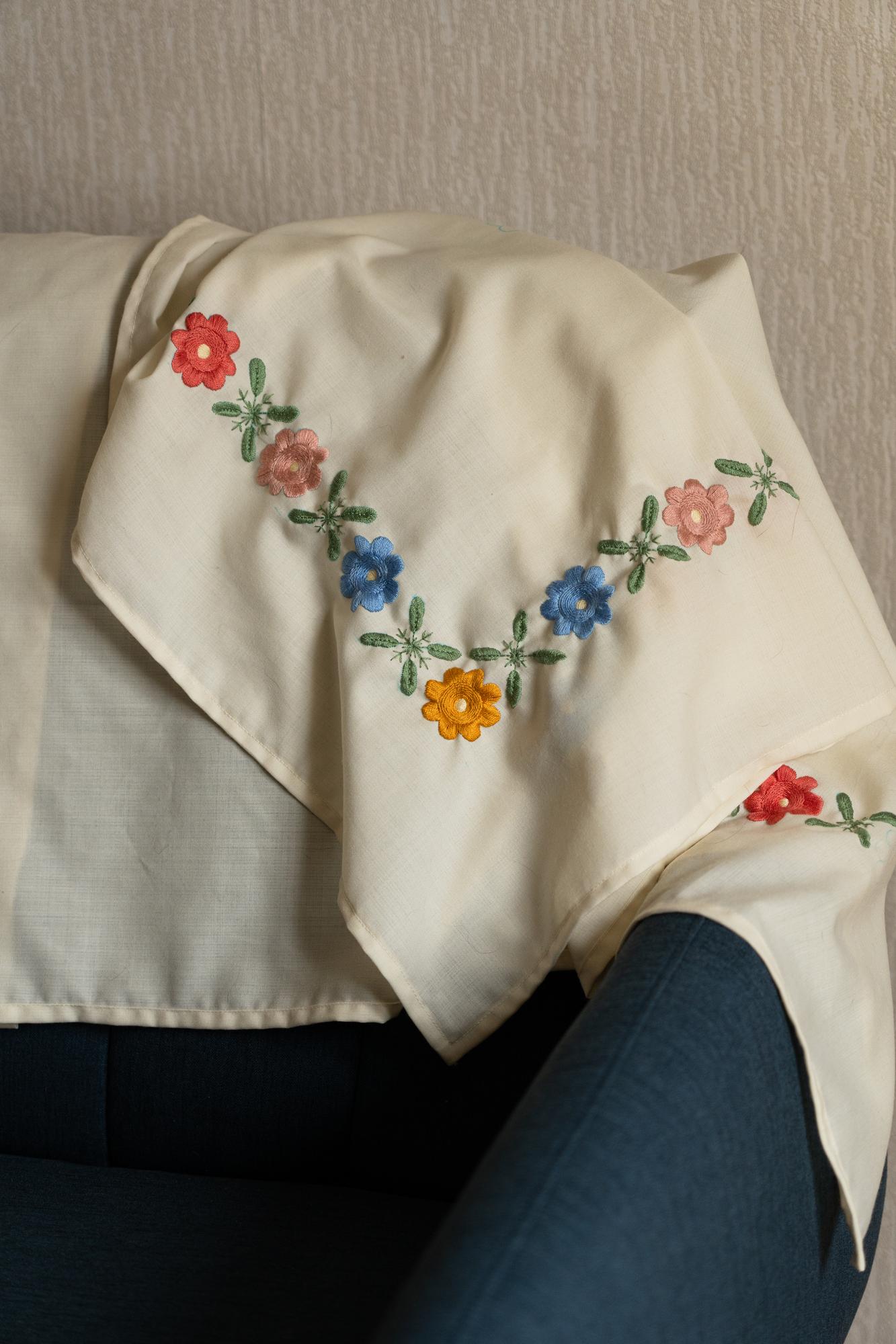 large editorial shot of embroidered textile draped on table
